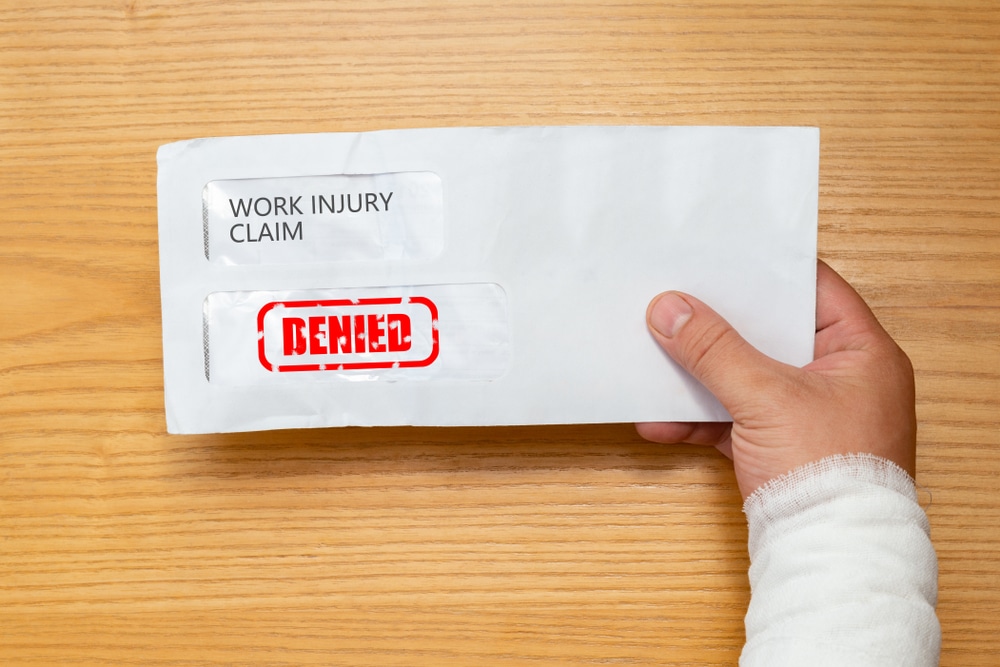WrappedHandHoldingAnEnvelopeWithAWorkInjuryClaim - Milwaukee Workers Compensation | Workers Comp Lawyer Milwaukee | Milwaukee Workers Compensation Attorney | Workmans Compensation Wisconsin WrappedHandHoldingAnEnvelopeWithAWorkInjuryClaim
